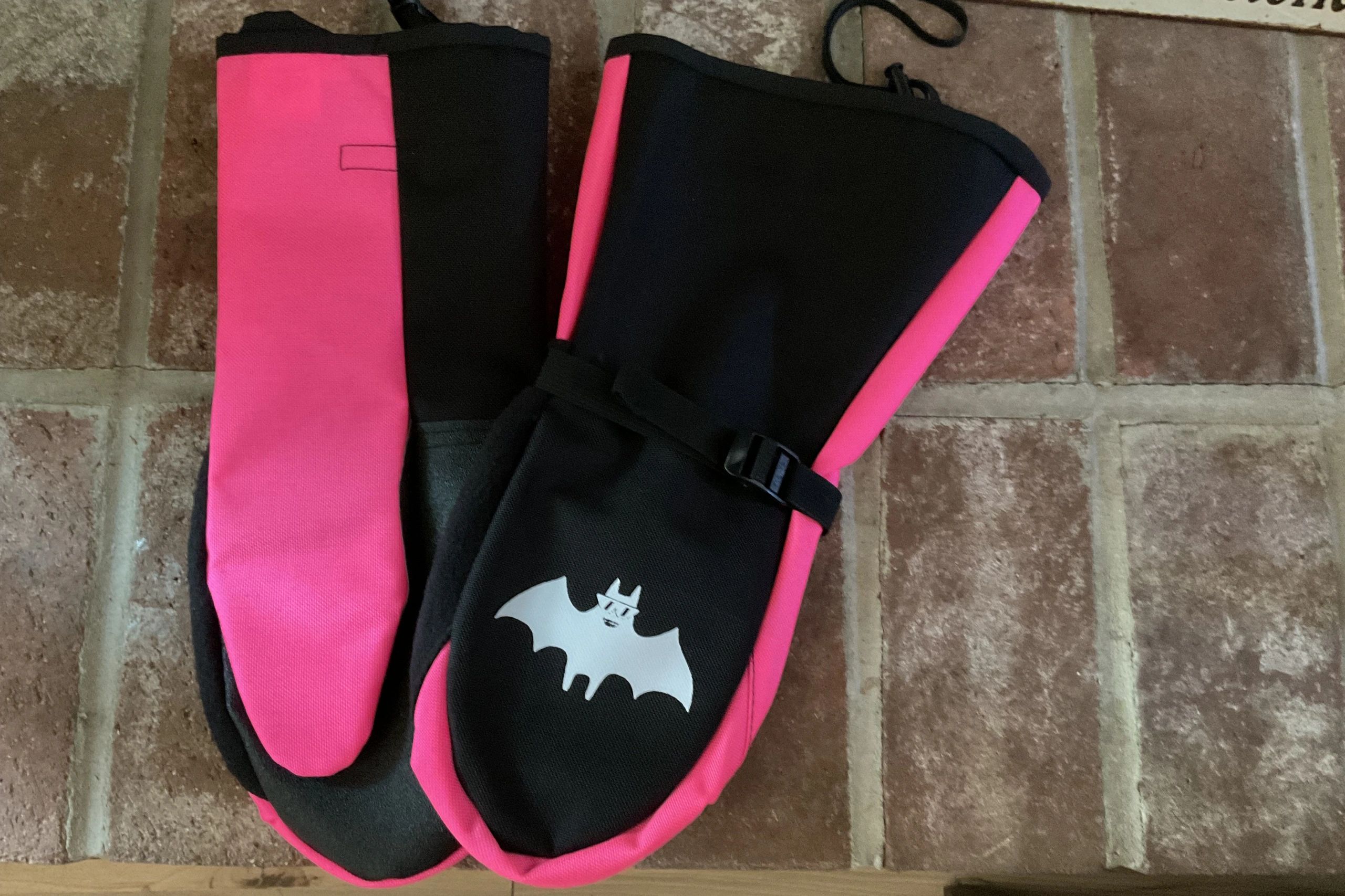 Neon pink and black socks with bat logo