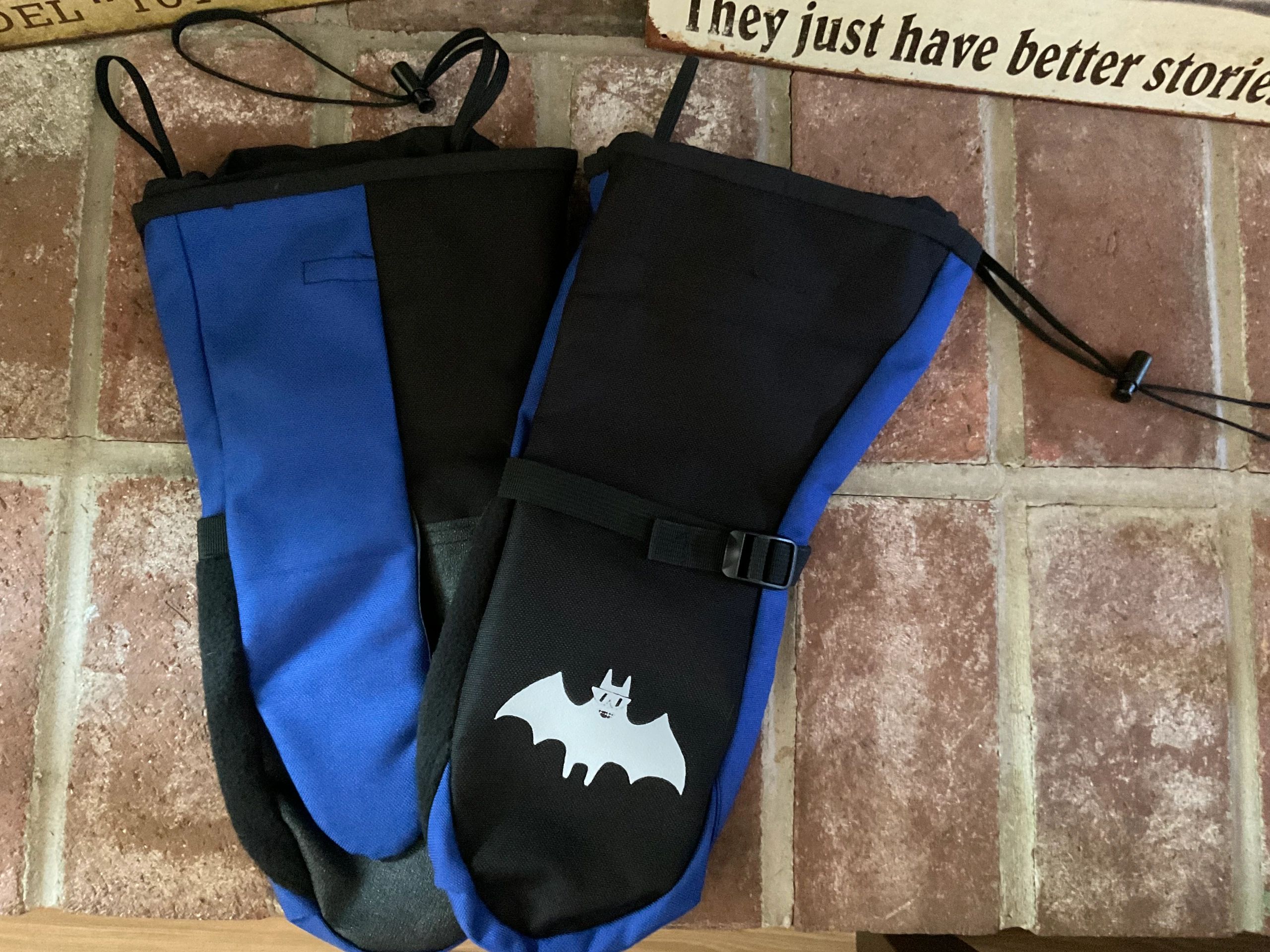 Children's blue and black mittens with bat logo